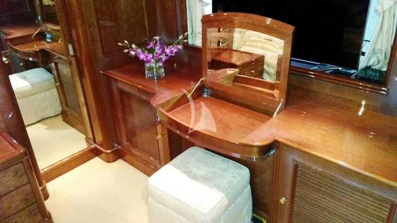a wooden table with a vase of flowers on it aboard SATINE Yacht for Sale