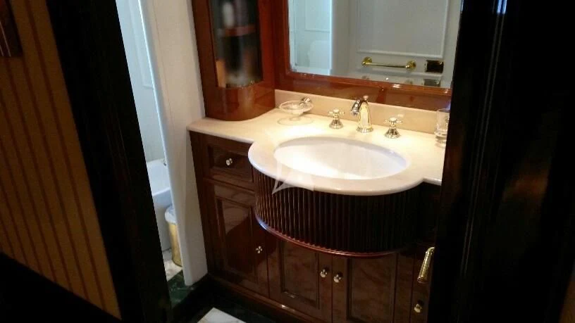 a bathroom with a sink and a mirror aboard SATINE Yacht for Sale