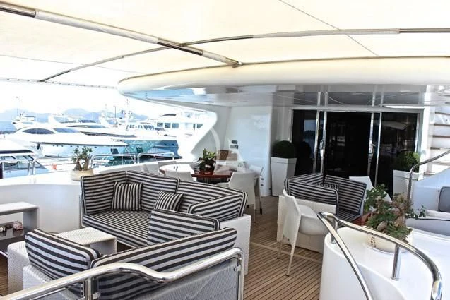 a room with a table chairs and a view of the water aboard SATINE Yacht for Sale