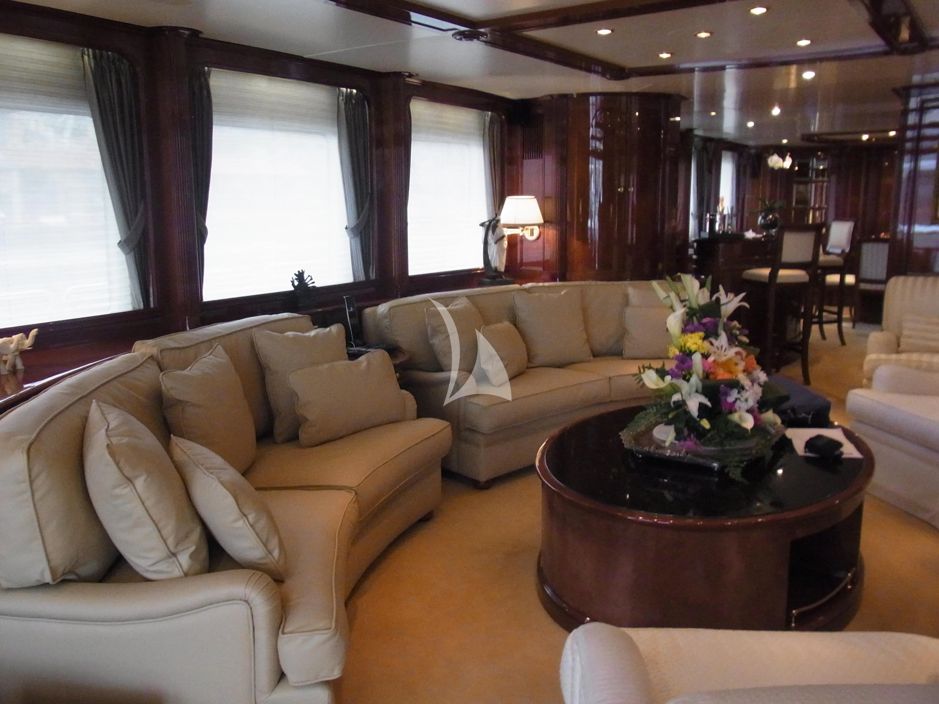 a living room with a table and couches aboard SATINE Yacht for Sale
