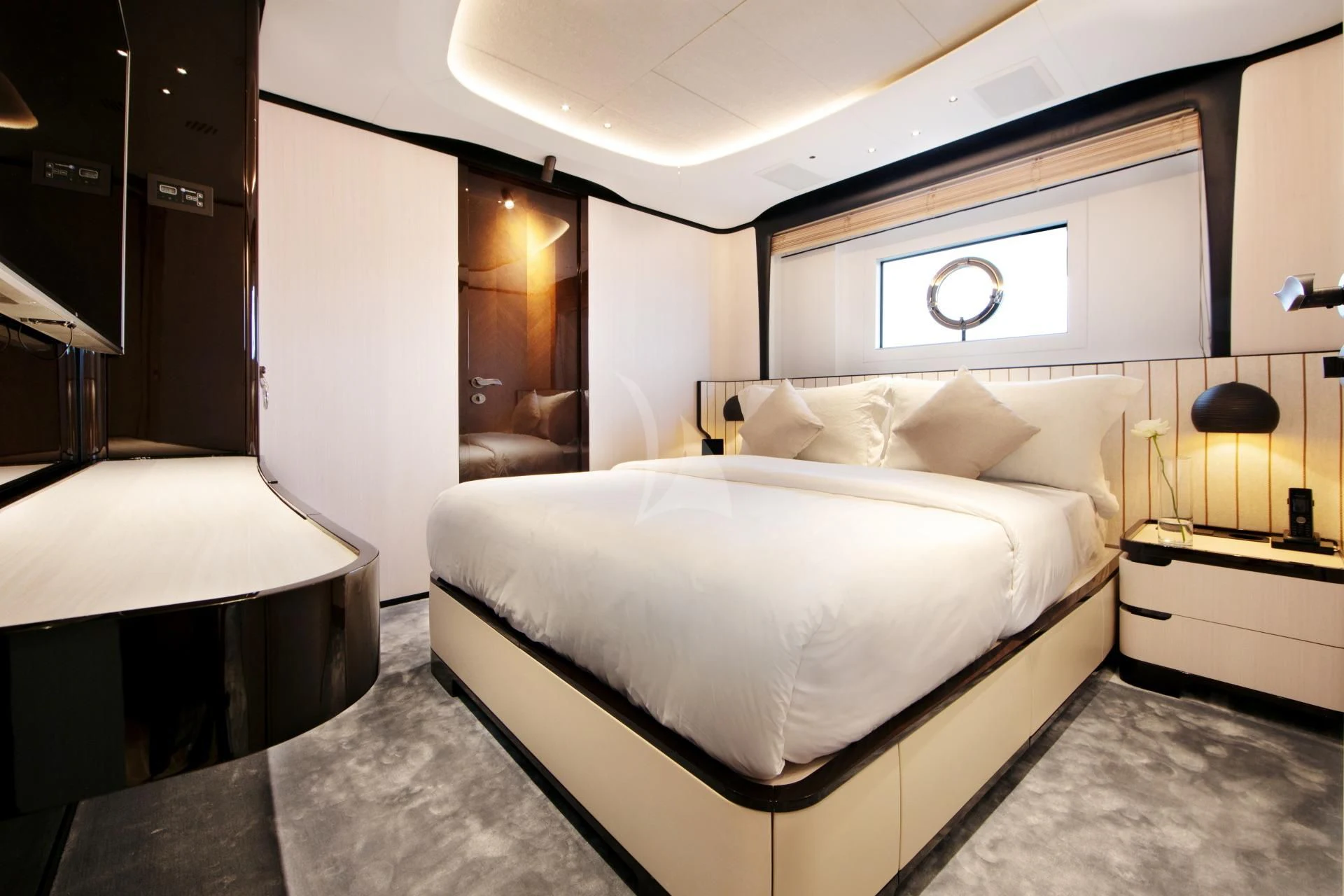 a room with a bed and a mirror aboard NAZ Yacht for Sale
