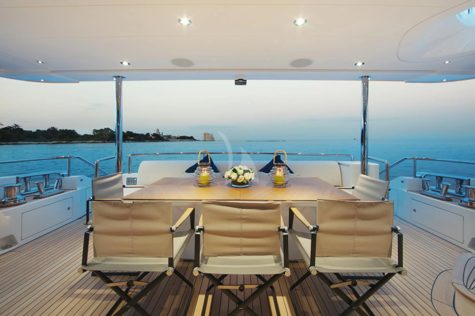 a table with chairs around it aboard NAZ Yacht for Sale