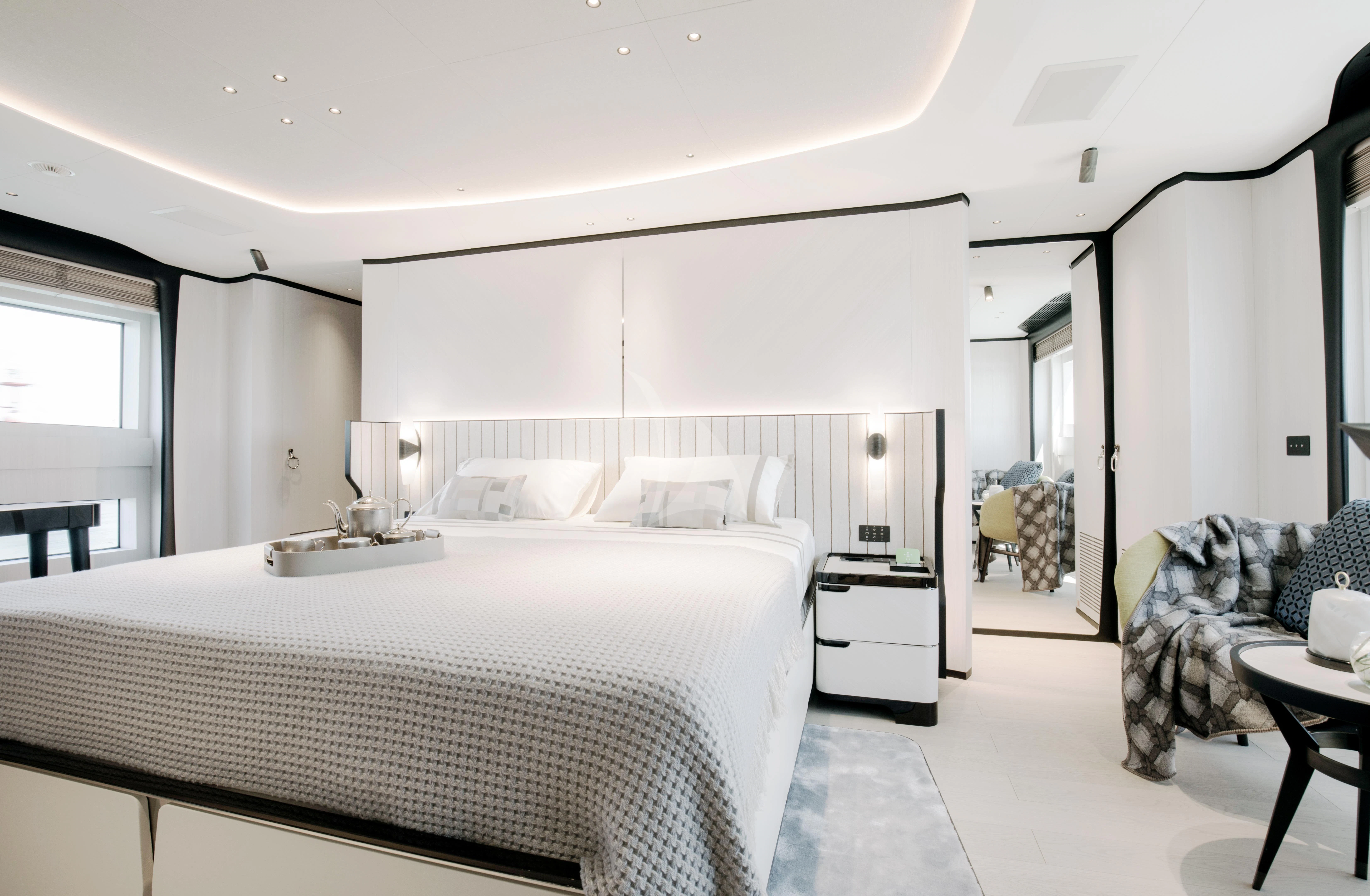 a bedroom with a bed and a couch aboard NAZ Yacht for Sale