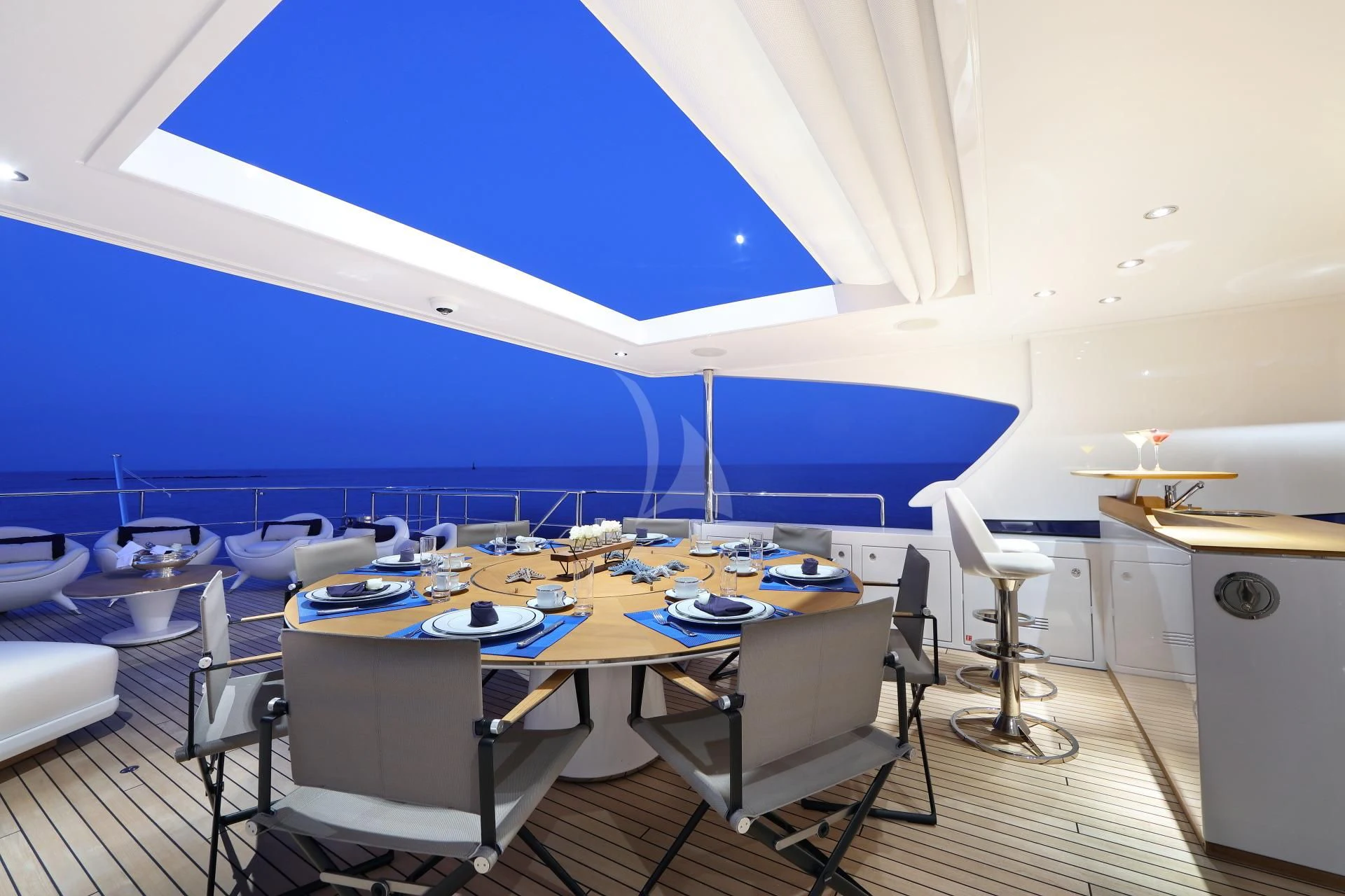 a room with a table and chairs aboard NAZ Yacht for Sale