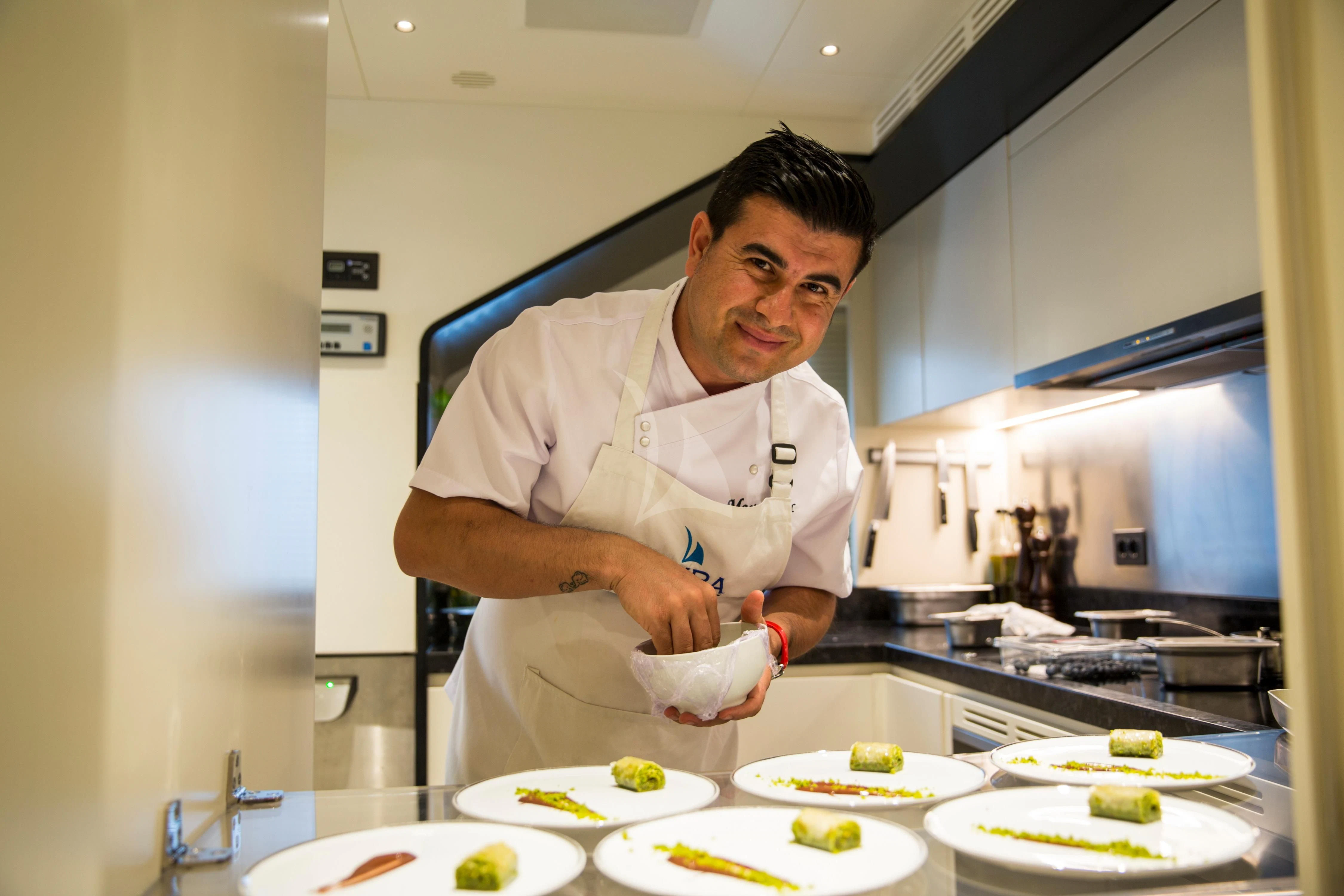 a chef in a kitchen aboard NAZ Yacht for Sale