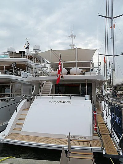 a large white boat in a harbor aboard NAZ Yacht for Sale