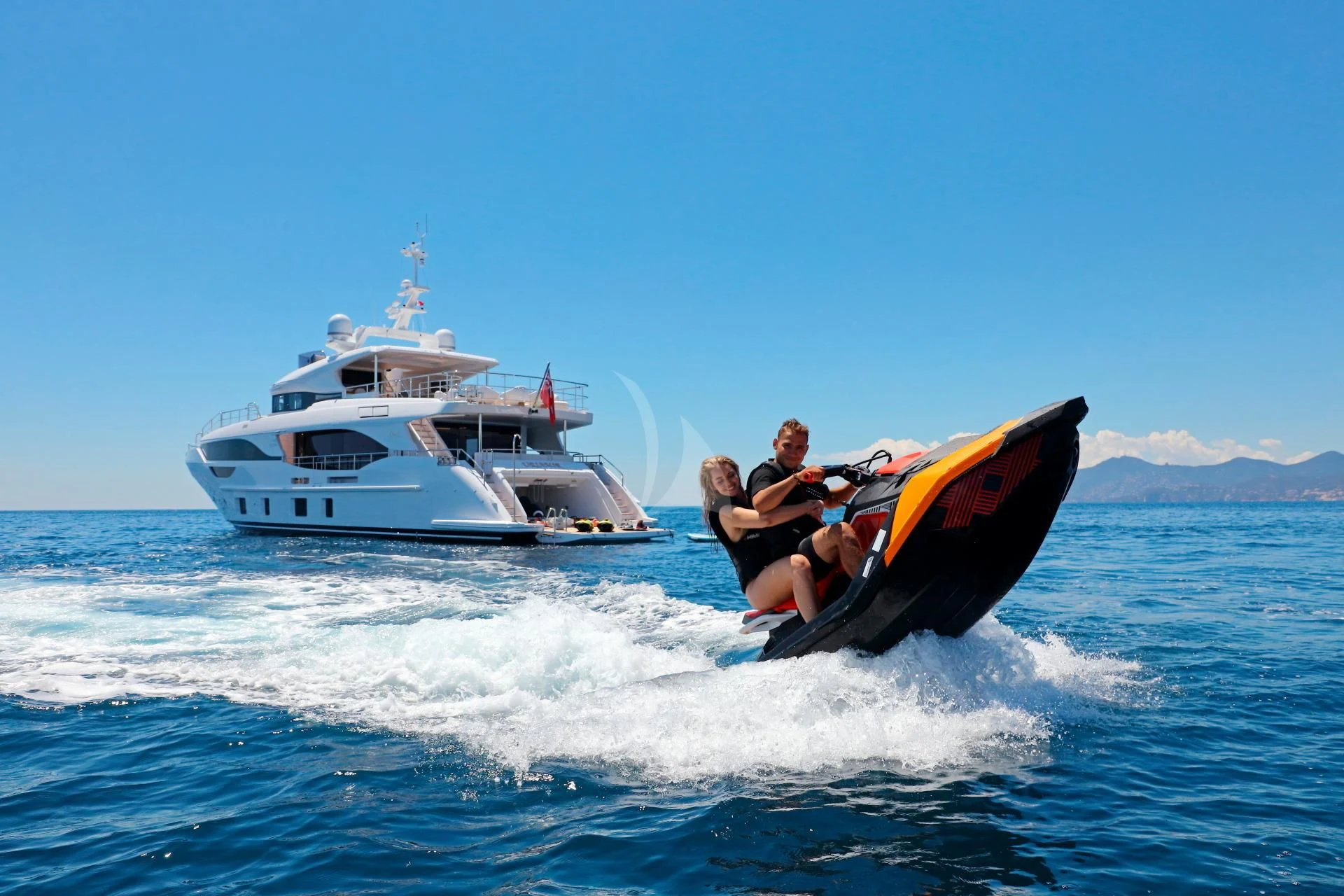 a man and a woman on a speedboat in the ocean aboard NAZ Yacht for Sale