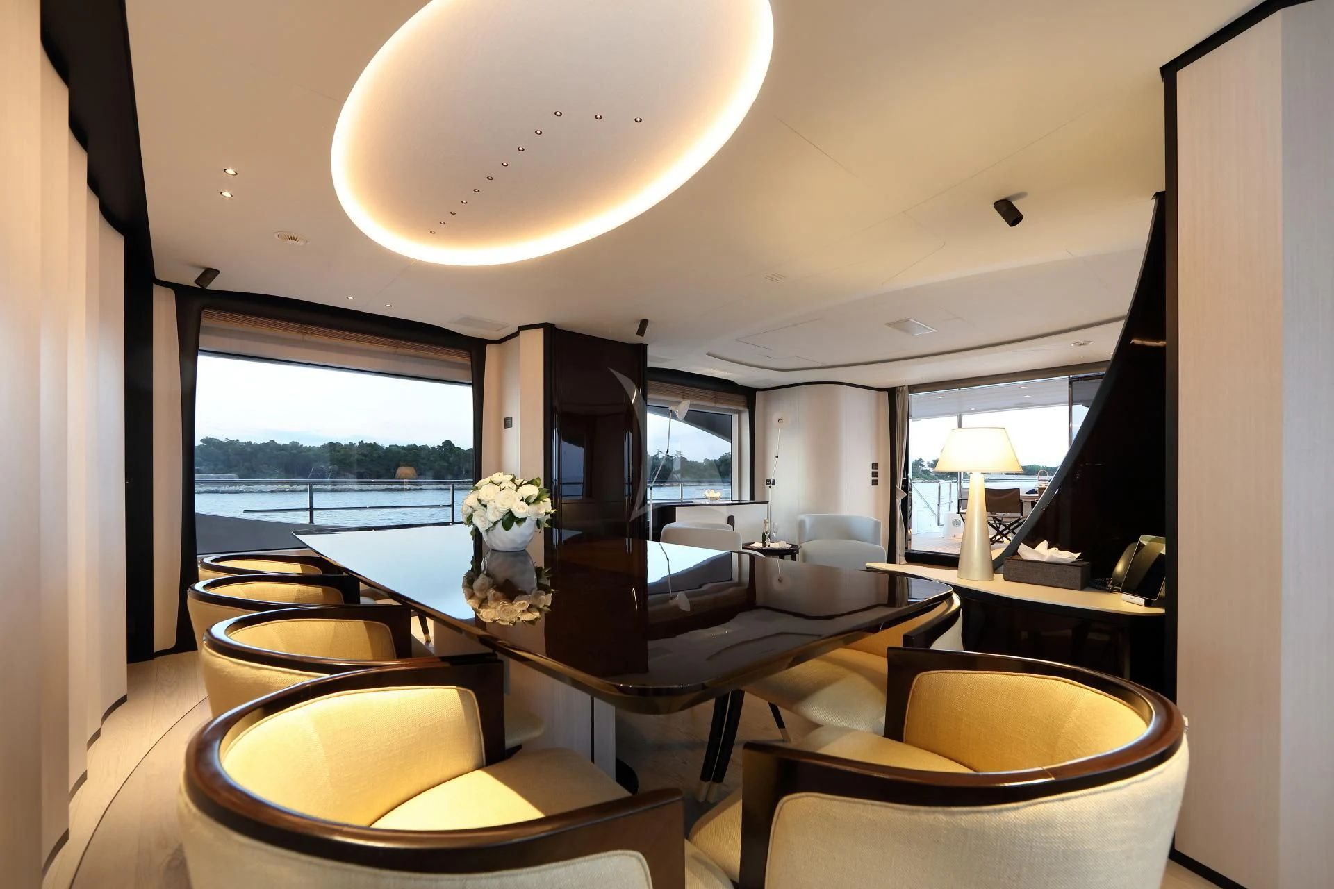 a room with a large table and chairs aboard NAZ Yacht for Sale