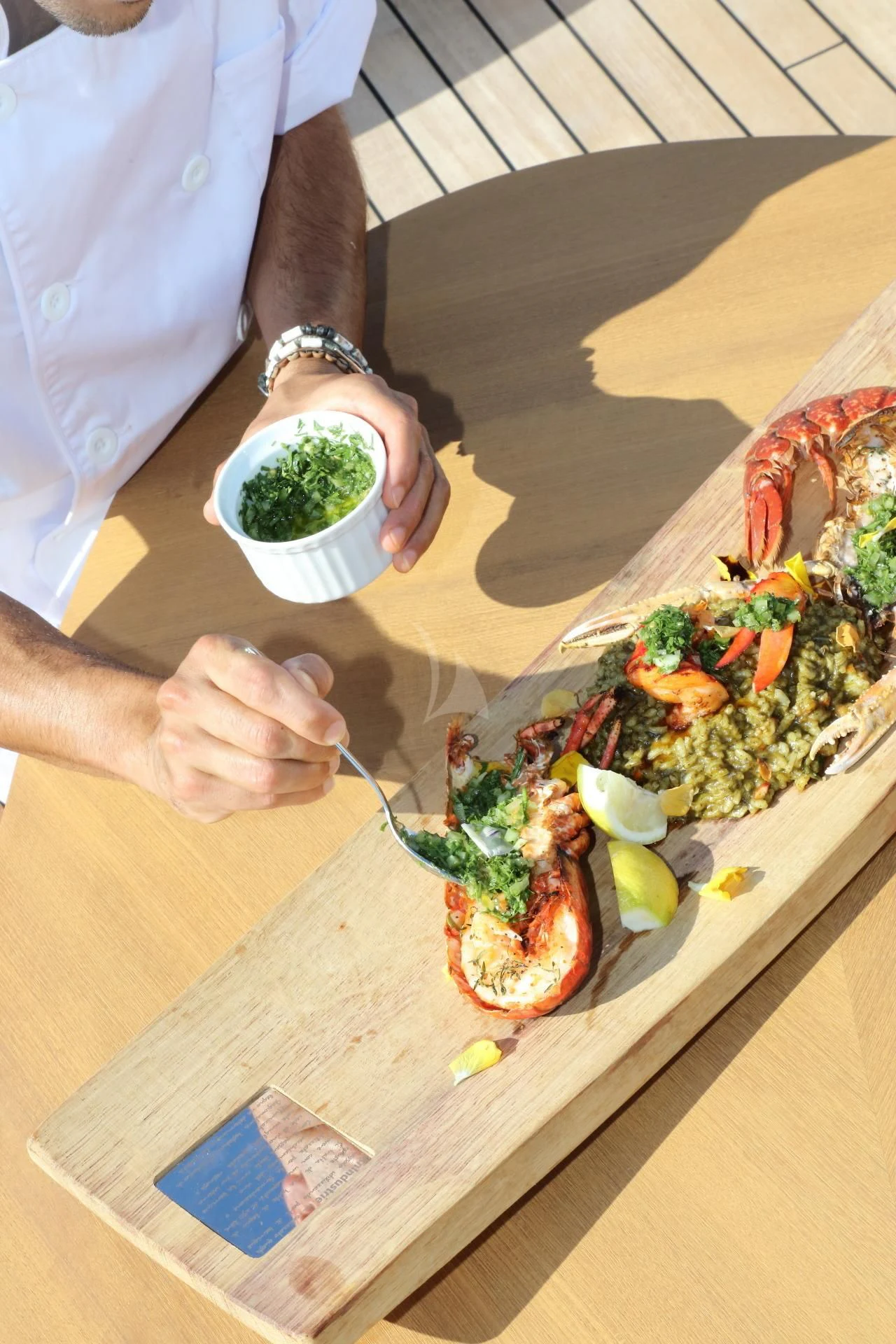 a person eating a salad aboard NAZ Yacht for Sale