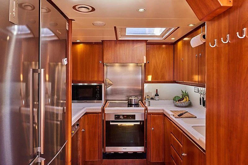 a kitchen with wooden cabinets aboard ANAMCARA Yacht for Sale