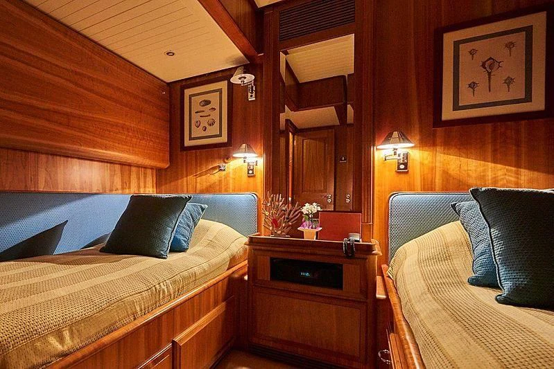 a room with a bed and a dresser aboard ANAMCARA Yacht for Sale