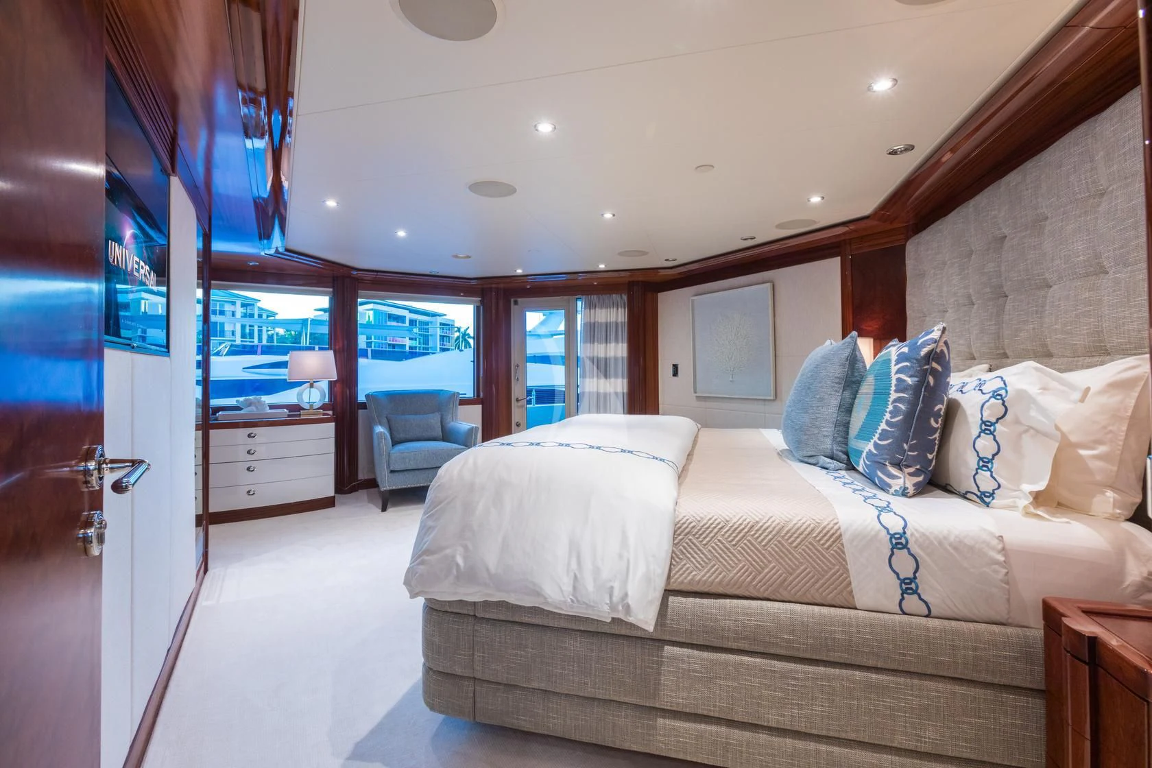a bedroom with a bed and a door aboard CHASING DAYLIGHT Yacht for Sale