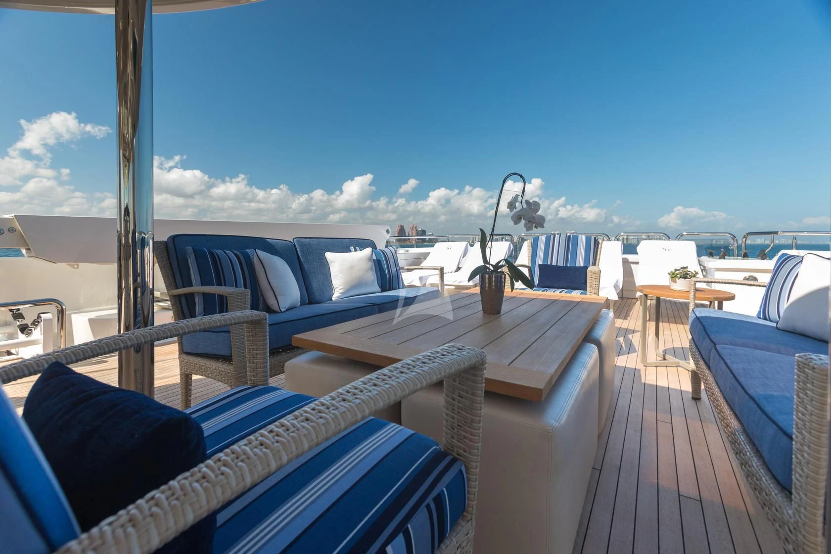 a deck with a view of the ocean and the city below aboard CHASING DAYLIGHT Yacht for Sale