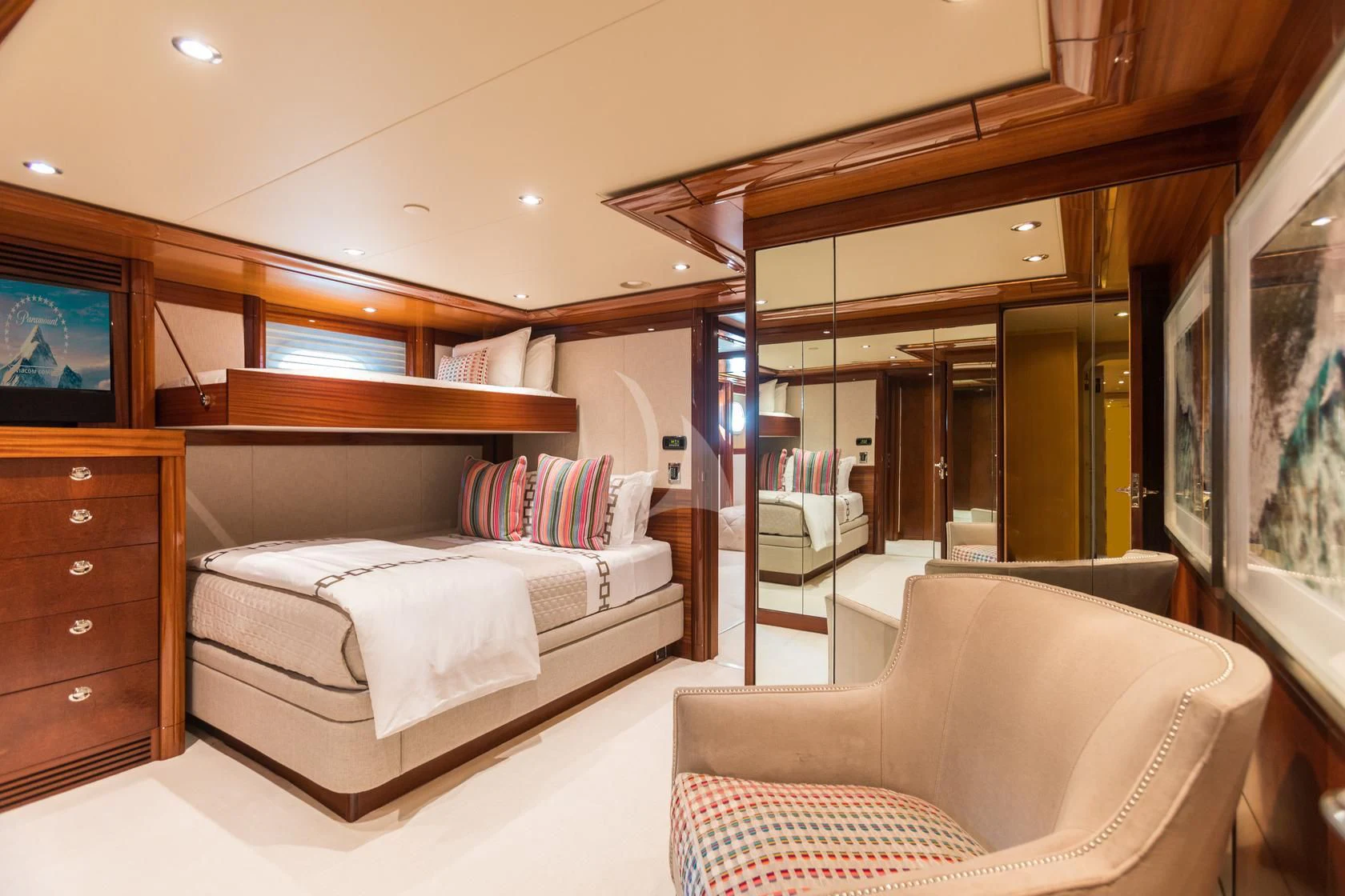 a room with a bed and a television aboard CHASING DAYLIGHT Yacht for Sale