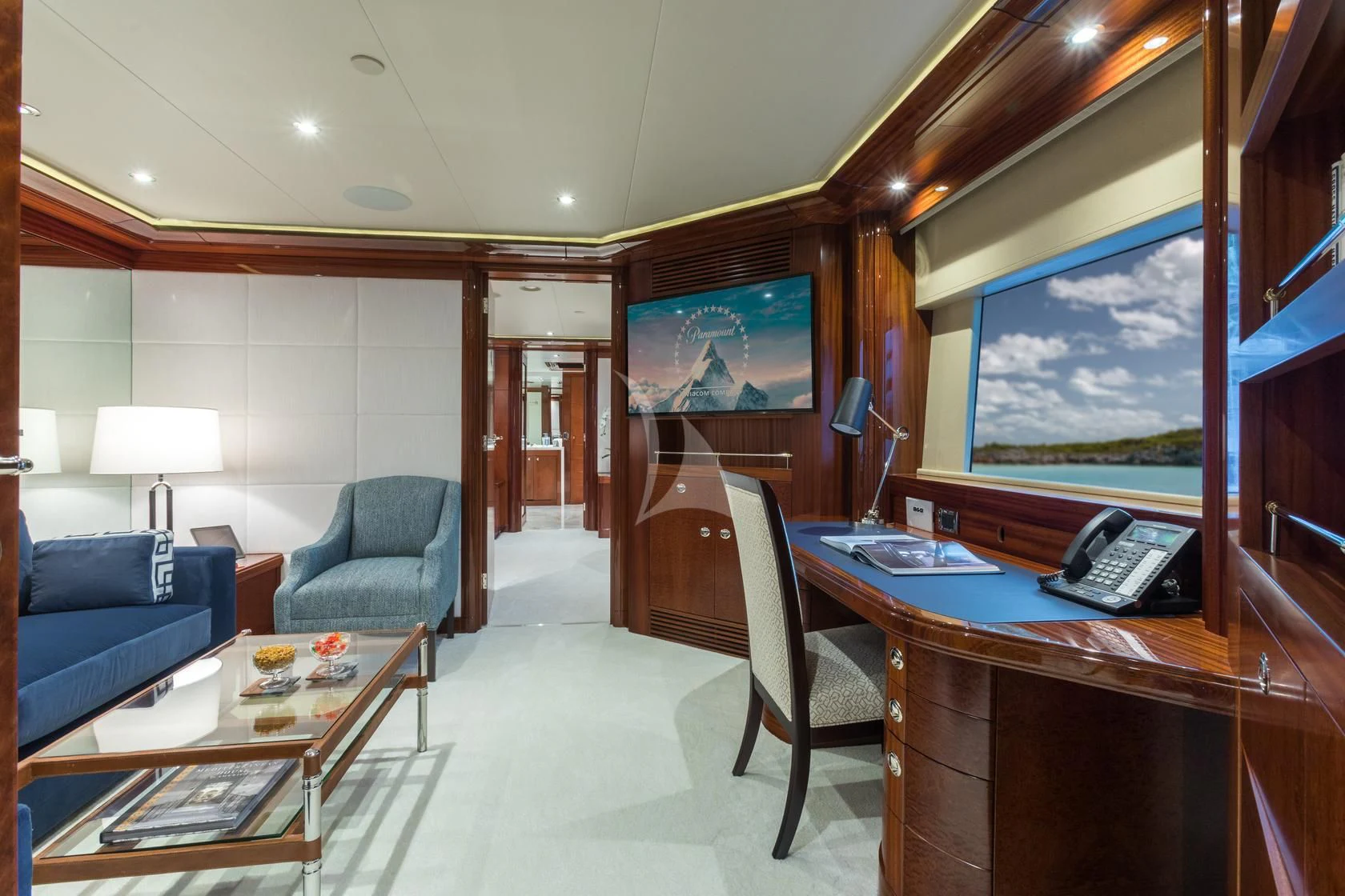 a living room with a desk and a tv aboard CHASING DAYLIGHT Yacht for Sale