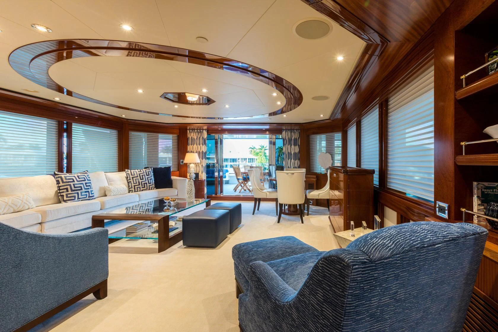 a living room with a large chandelier aboard CHASING DAYLIGHT Yacht for Sale