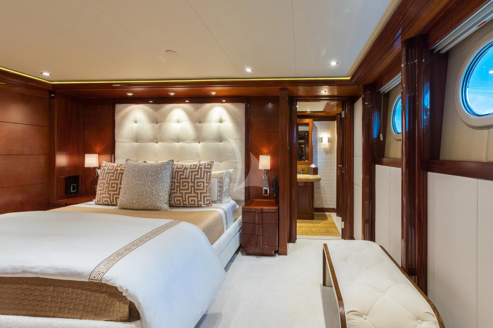 a room with a bed and a chair aboard CHASING DAYLIGHT Yacht for Sale