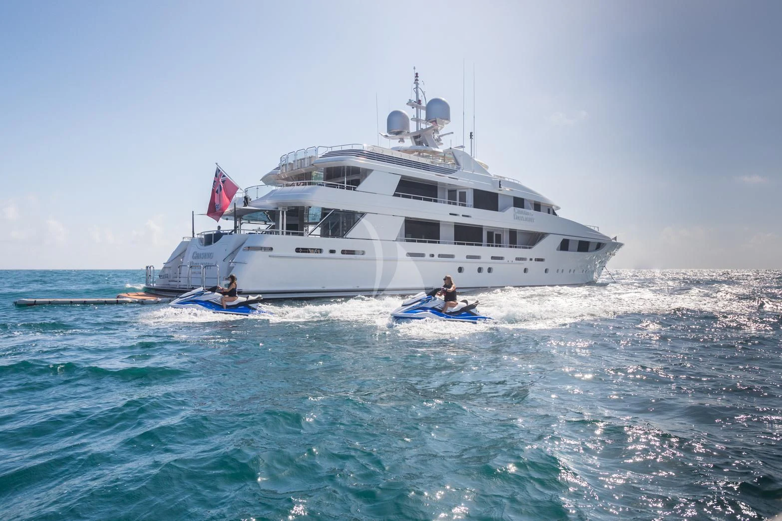 a large white boat with a flag on it aboard CHASING DAYLIGHT Yacht for Sale