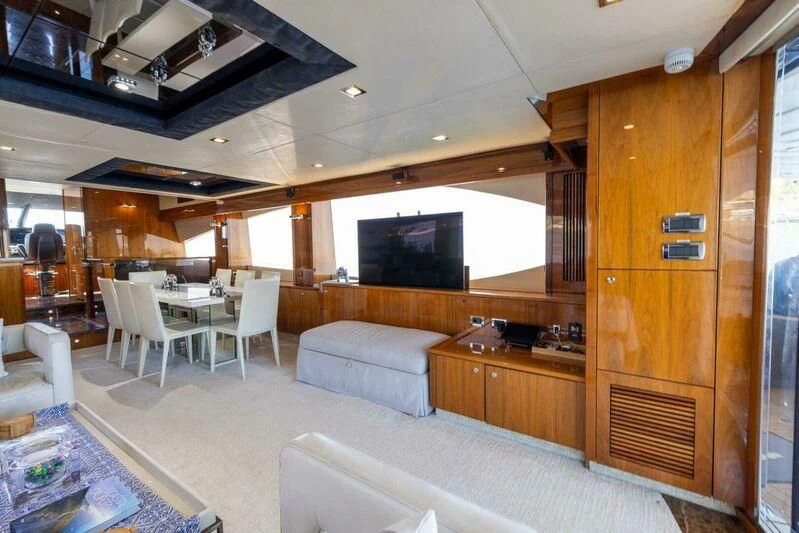 a living room with a wood cabinet aboard INDECENT PROPOSAL 4 Yacht for Sale