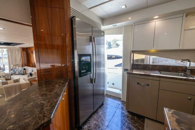 a kitchen with a large refrigerator aboard INDECENT PROPOSAL 4 Yacht for Sale