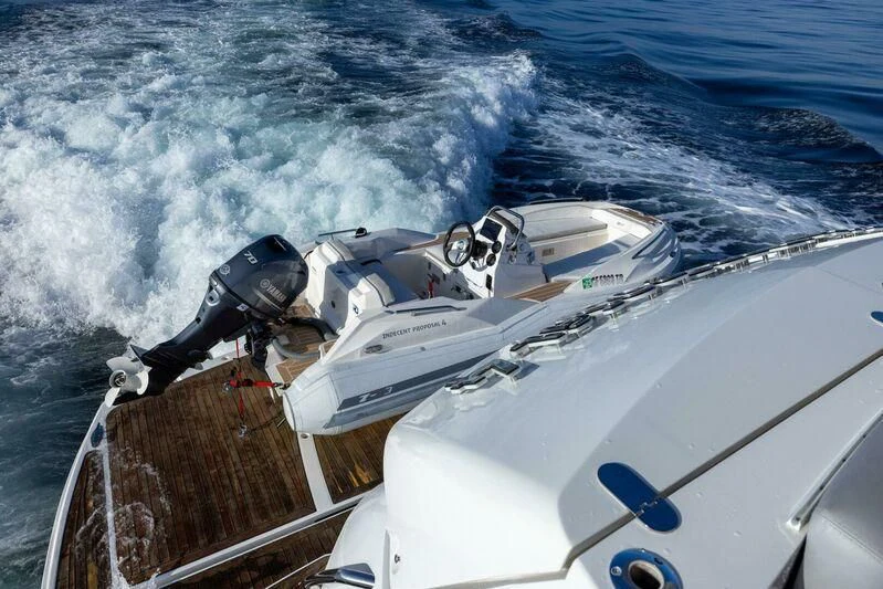 a boat with a motor attached to it aboard INDECENT PROPOSAL 4 Yacht for Sale