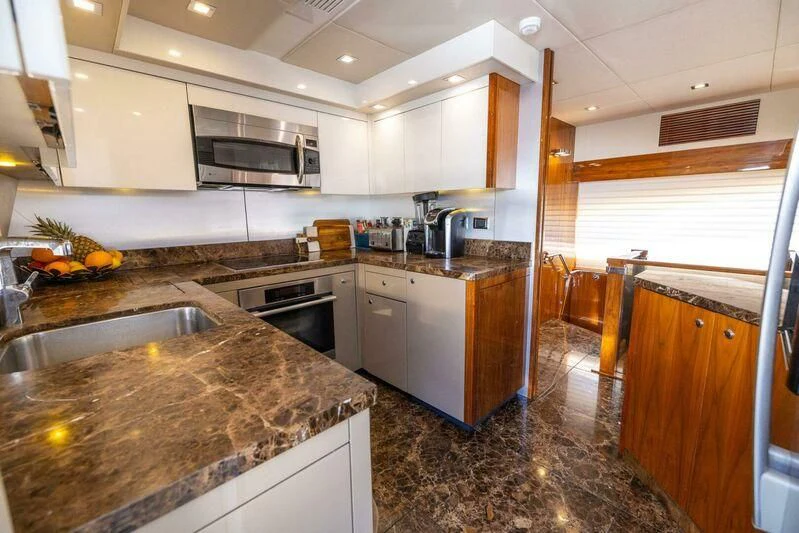 a kitchen with marble counters aboard INDECENT PROPOSAL 4 Yacht for Sale