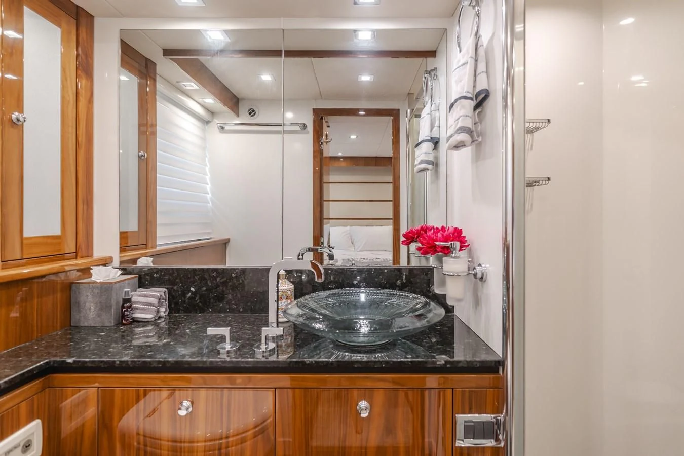 a bathroom with a sink and cabinets aboard INDECENT PROPOSAL 4 Yacht for Sale