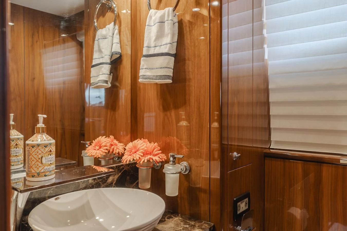 a bathroom with a sink and a mirror aboard INDECENT PROPOSAL 4 Yacht for Sale