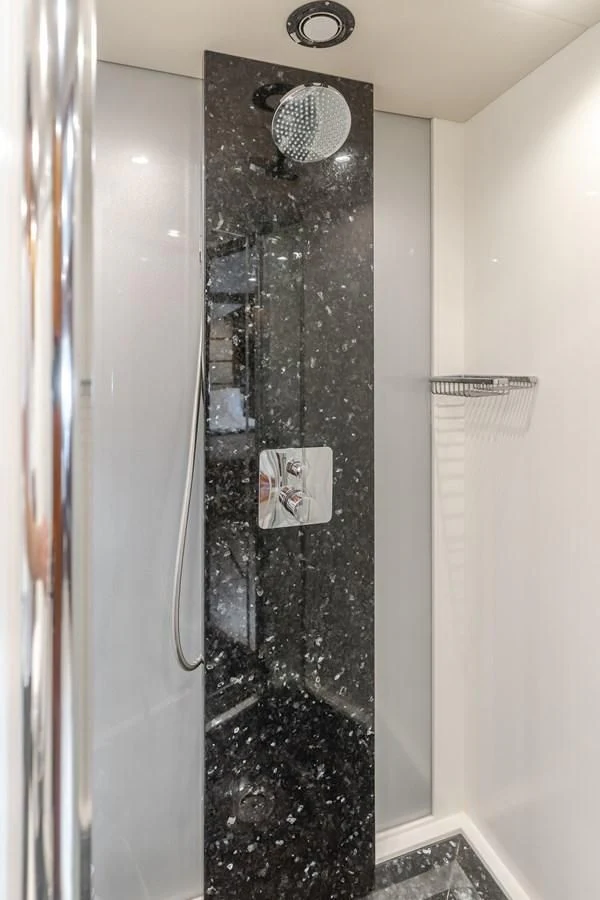 a shower with a black wall aboard INDECENT PROPOSAL 4 Yacht for Sale