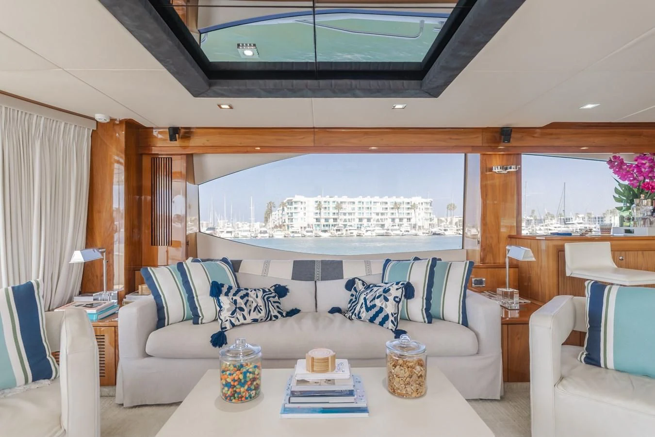 a living room with a large window aboard INDECENT PROPOSAL 4 Yacht for Sale