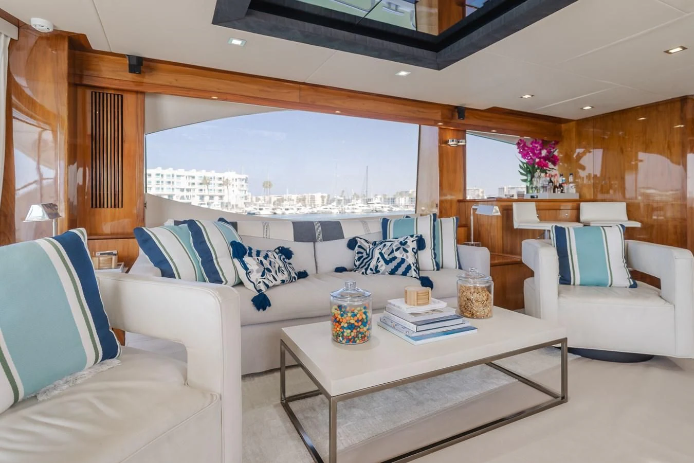 a living room with a large window aboard INDECENT PROPOSAL 4 Yacht for Sale
