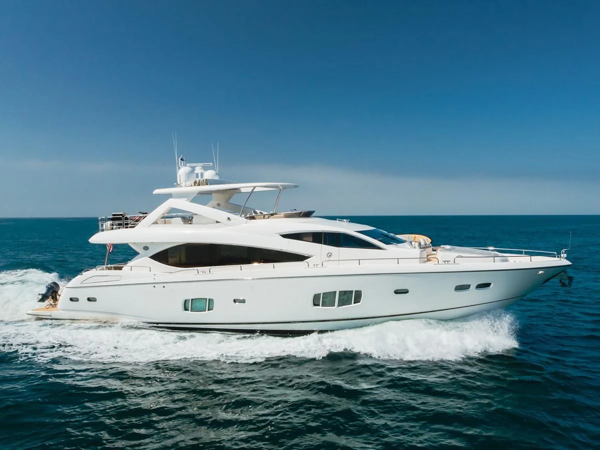 a white yacht on the water aboard INDECENT PROPOSAL 4 Yacht for Sale