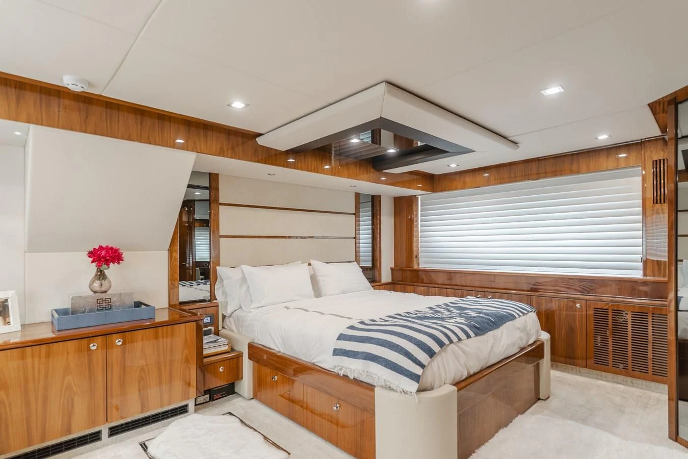 a bedroom with a bed and a desk aboard INDECENT PROPOSAL 4 Yacht for Sale