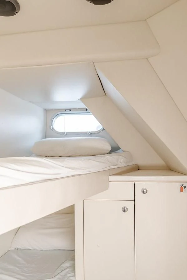 a room with a bed and a window aboard INDECENT PROPOSAL 4 Yacht for Sale