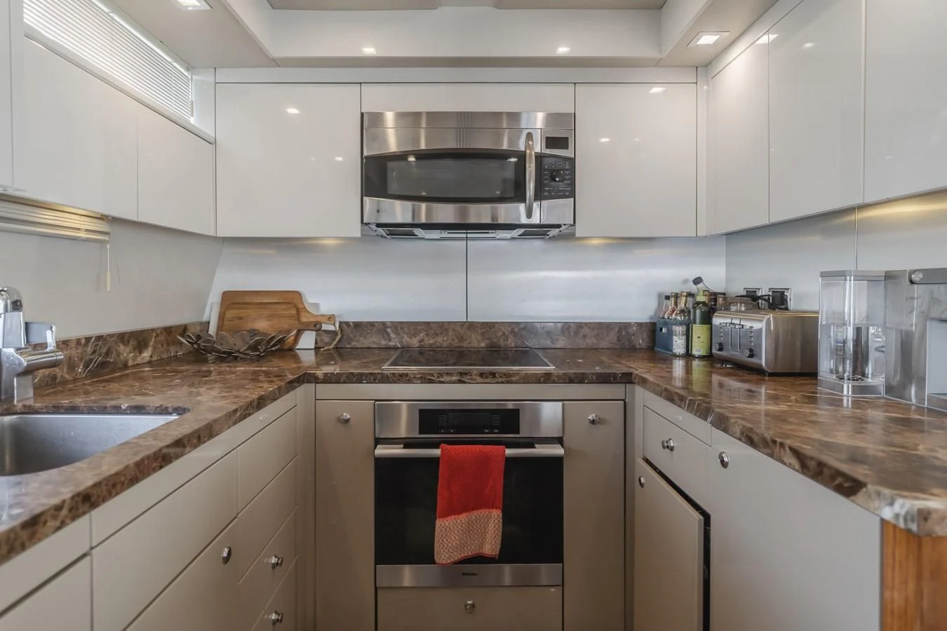 a kitchen with a microwave oven and a stove aboard INDECENT PROPOSAL 4 Yacht for Sale