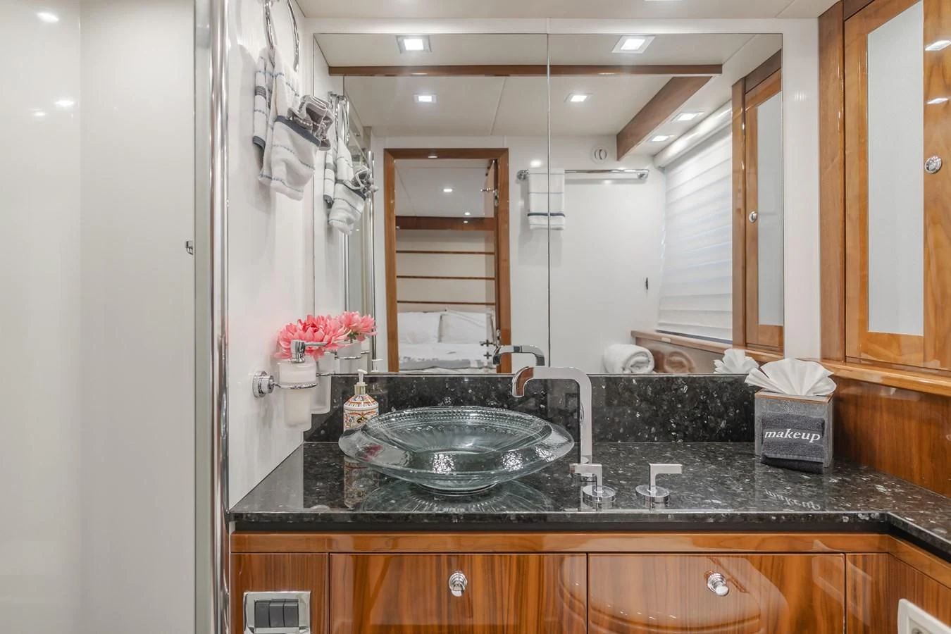 a bathroom with a sink and cabinets aboard INDECENT PROPOSAL 4 Yacht for Sale