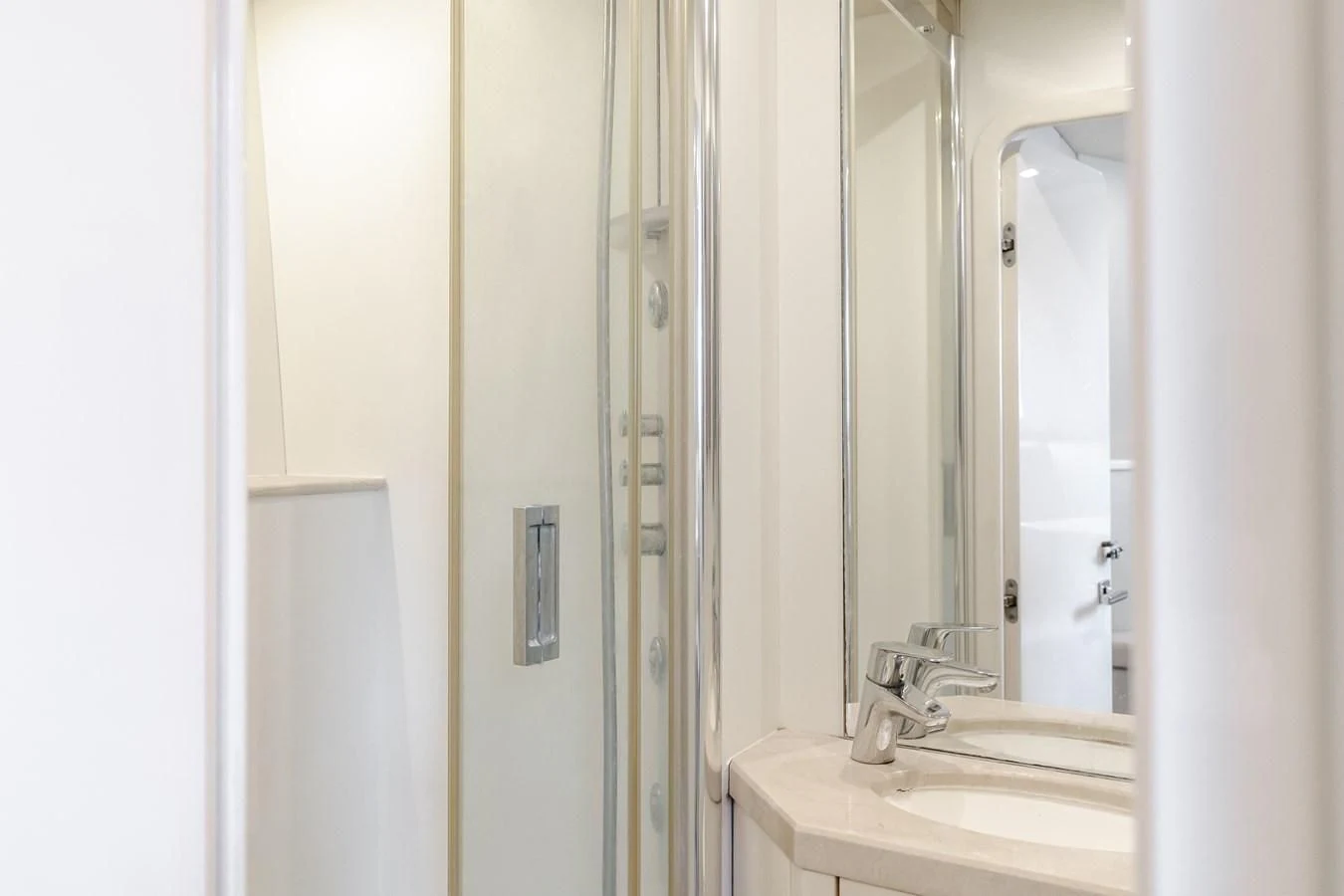 a bathroom with a sink and a mirror aboard INDECENT PROPOSAL 4 Yacht for Sale