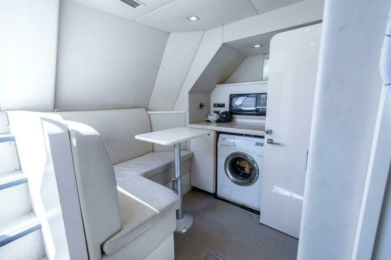 a room with a washing machine and a chair aboard INDECENT PROPOSAL 4 Yacht for Sale
