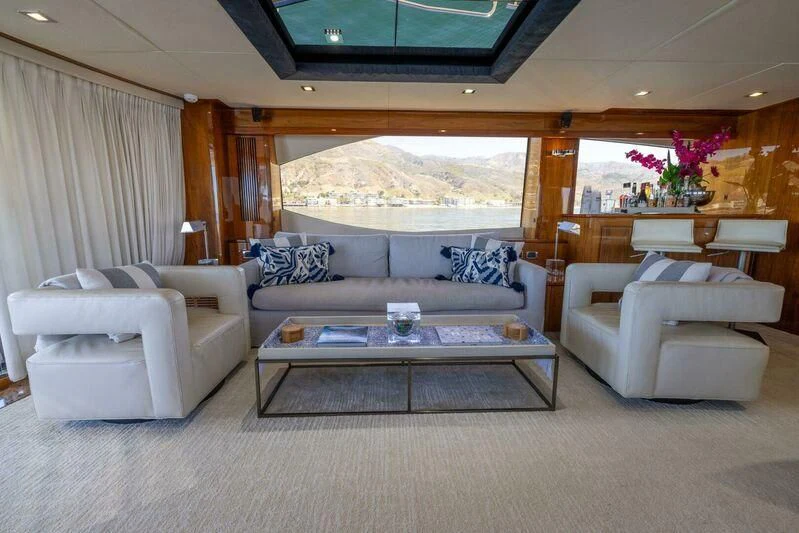 a living room with a couch and a coffee table aboard INDECENT PROPOSAL 4 Yacht for Sale