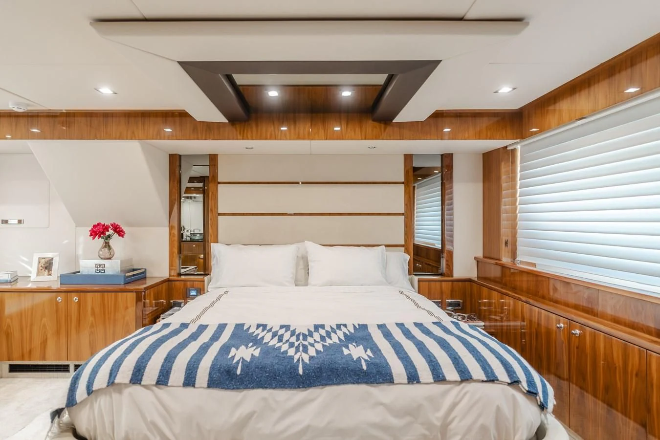 a bed with a blue and white sheet and a white pillow aboard INDECENT PROPOSAL 4 Yacht for Sale