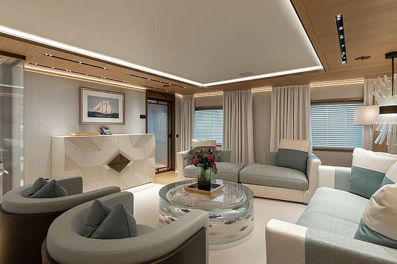 a living room with white couches and a table aboard LA DATCHA Yacht for Sale