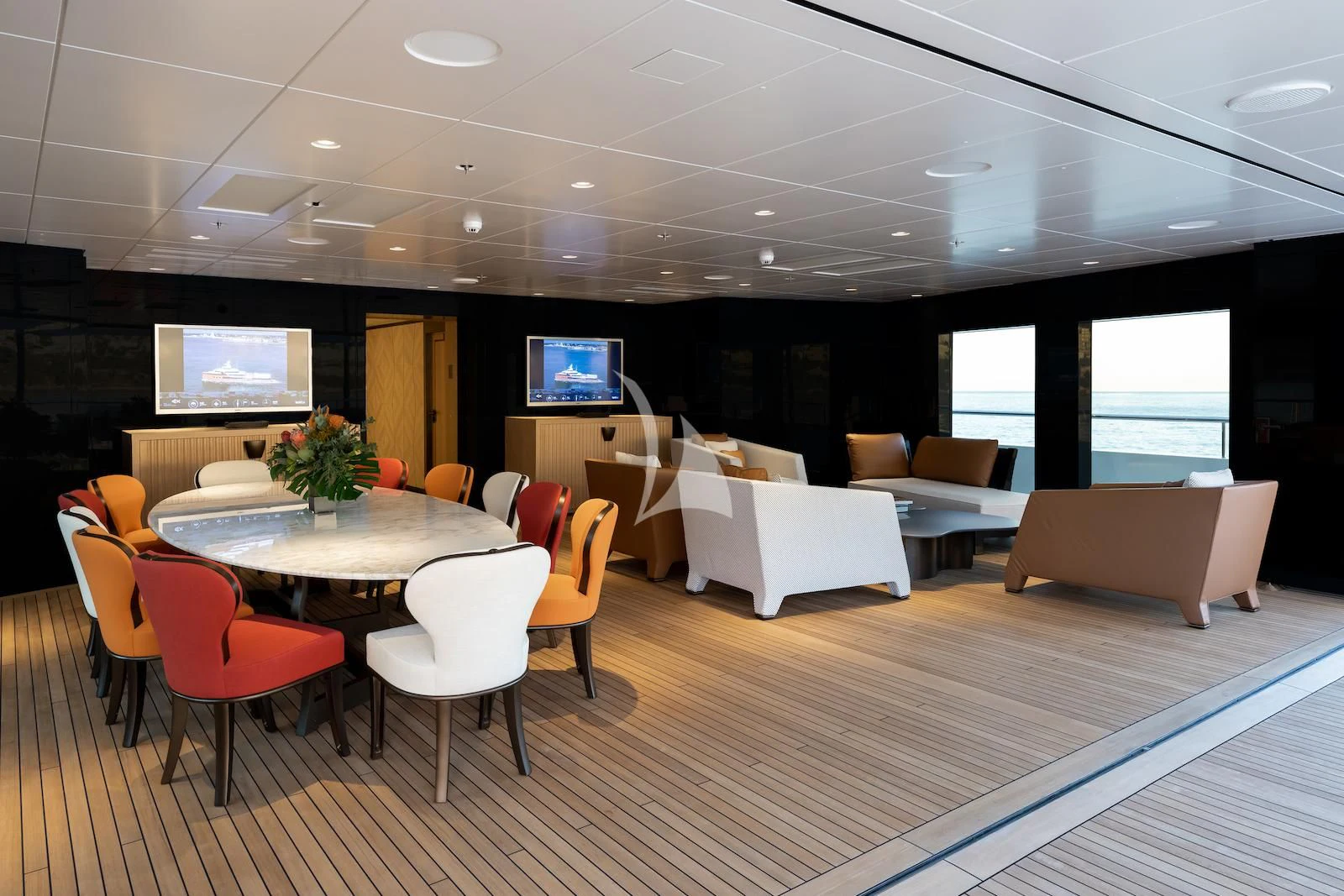 a room with tables and chairs aboard LA DATCHA Yacht for Sale