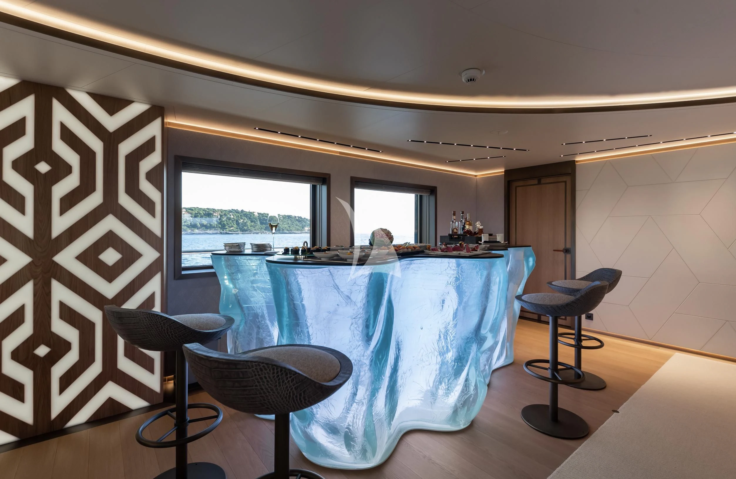 a large kitchen with a large blue table and chairs aboard LA DATCHA Yacht for Sale