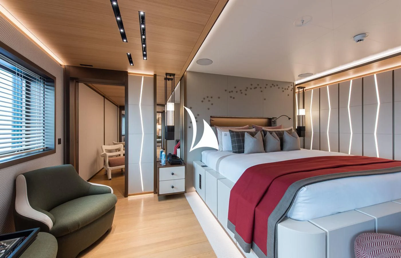 a bedroom with a bed and a chair aboard LA DATCHA Yacht for Sale