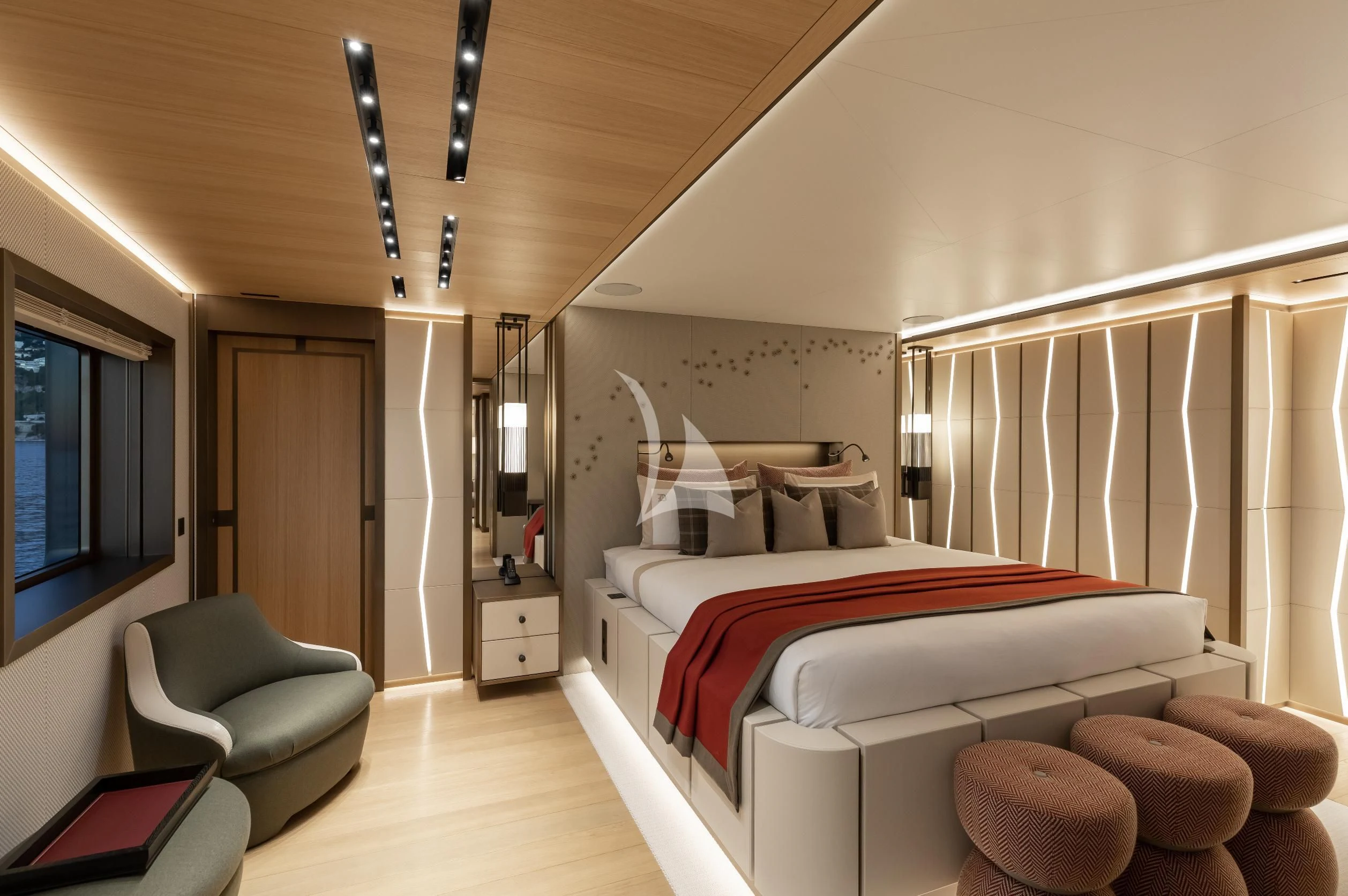 a bedroom with a bed and a chair aboard LA DATCHA Yacht for Sale
