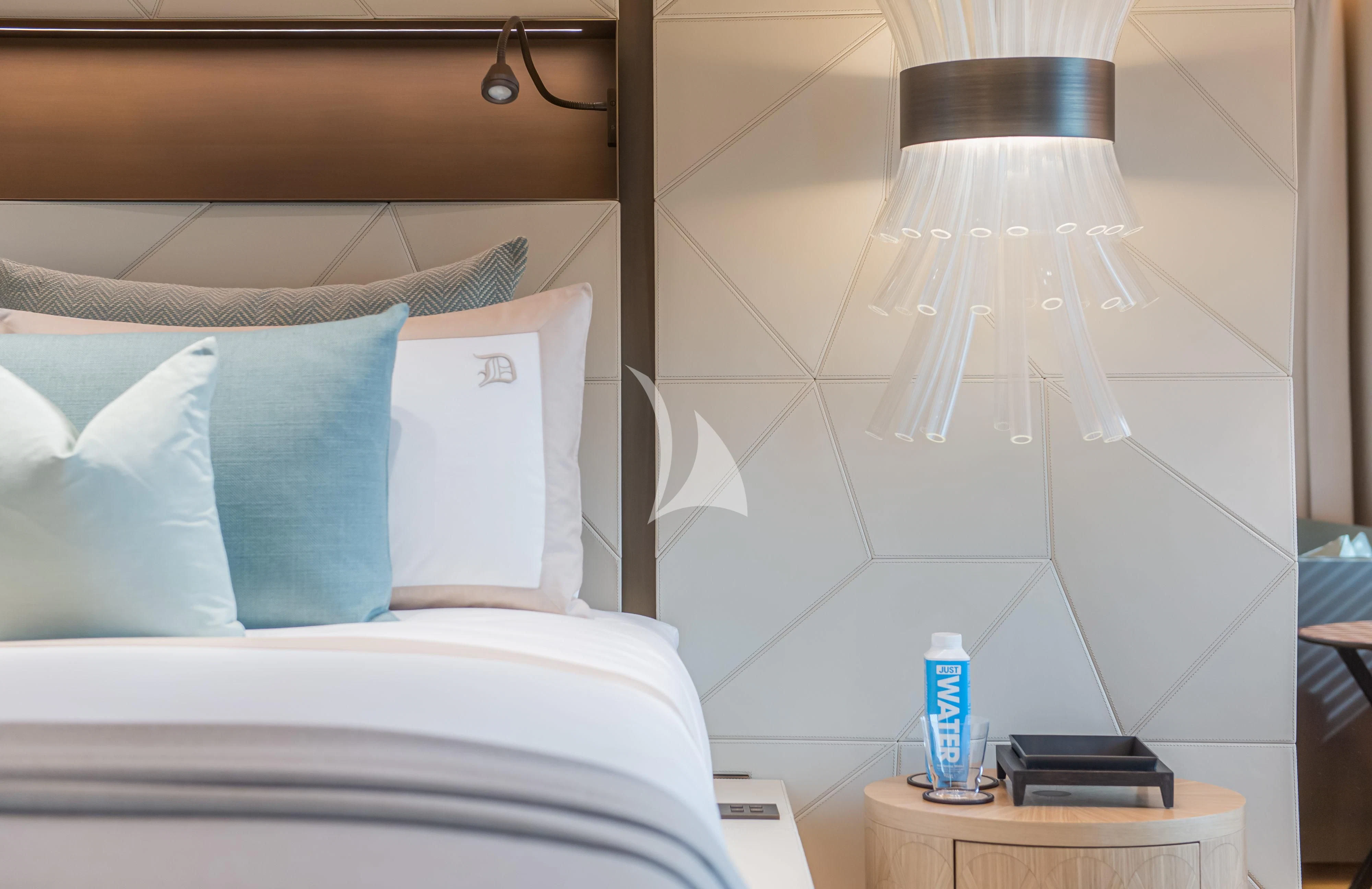 a bed with a lamp on it aboard LA DATCHA Yacht for Sale