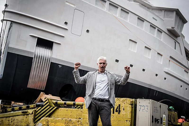 a man holding a drill aboard LA DATCHA Yacht for Sale