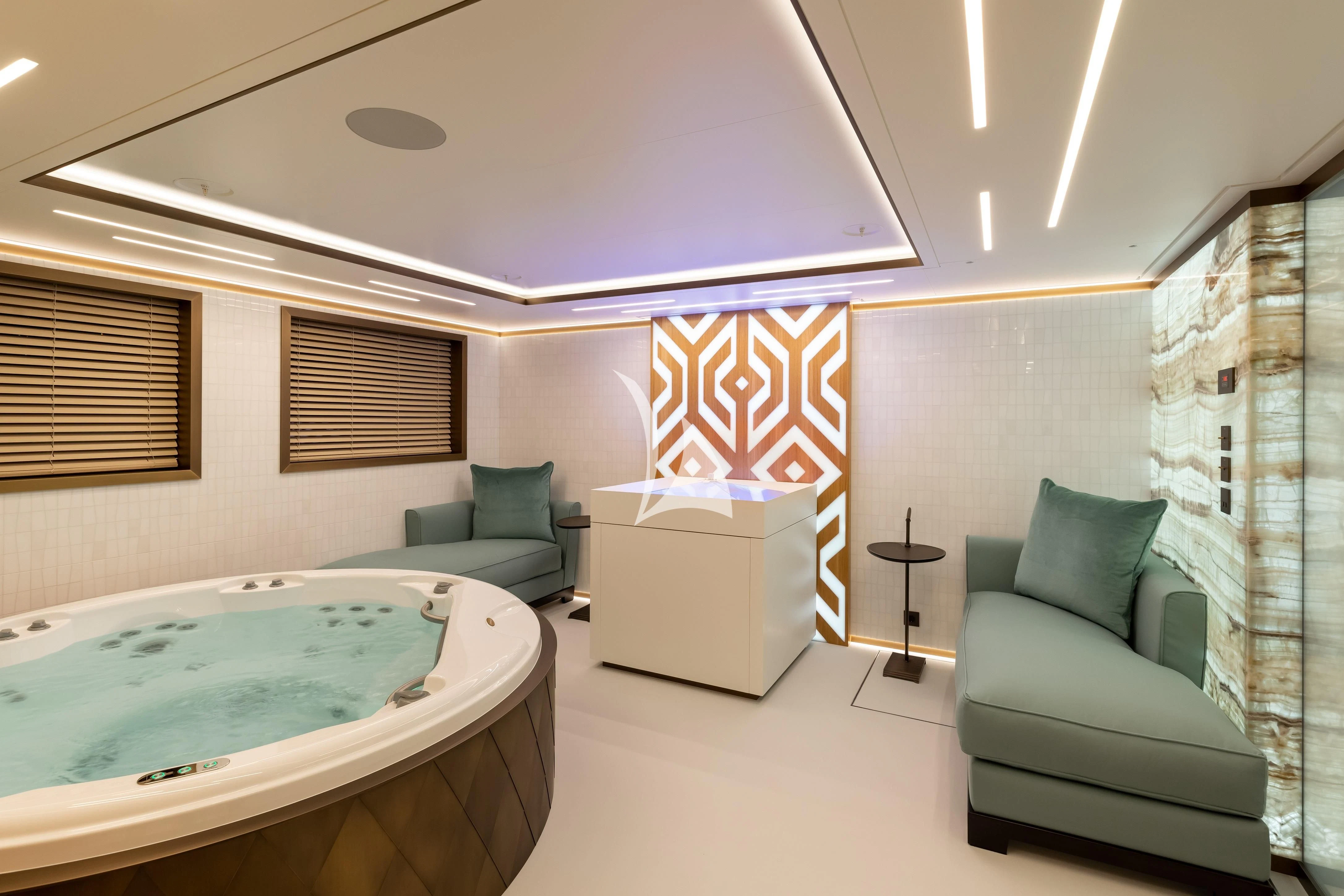 a bedroom with a bed and a couch aboard LA DATCHA Yacht for Sale