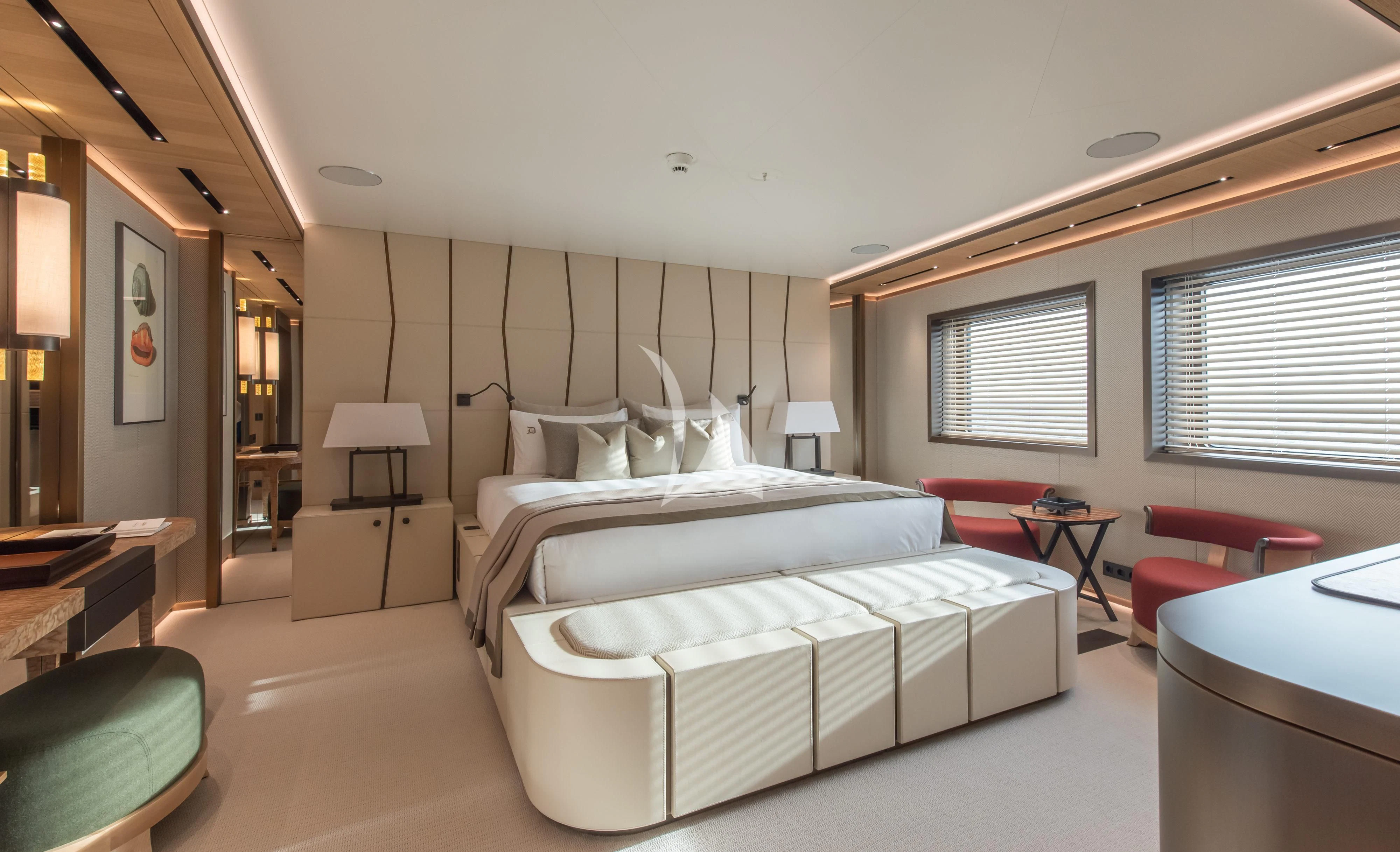 a bedroom with a bed and a desk aboard LA DATCHA Yacht for Sale