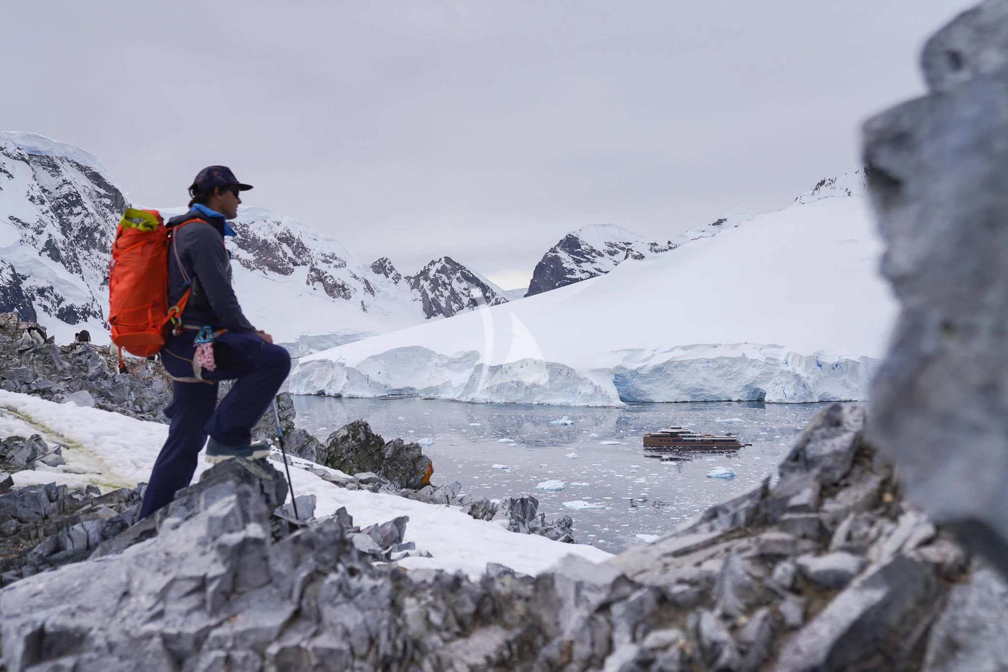 a man hiking on a rocky mountain aboard LA DATCHA Yacht for Sale
